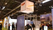 Side view of the IDAE stand and visitors at a trade fair